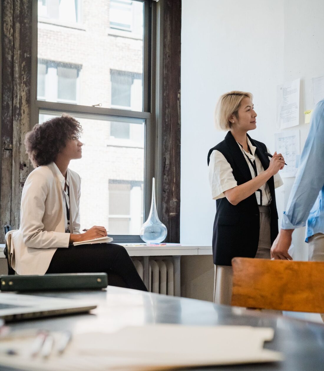 Two agents discussing instructions in a bright office