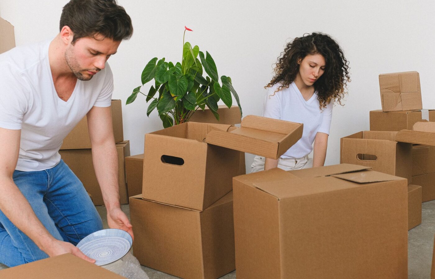 Couple unpacking boxes in their new home