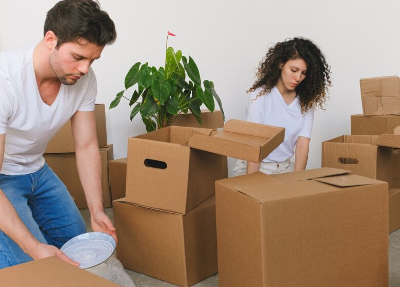 Couple unpacking boxes in their new home